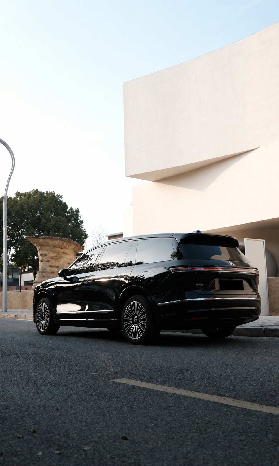 Black luxury SUV parked beside a modern building
